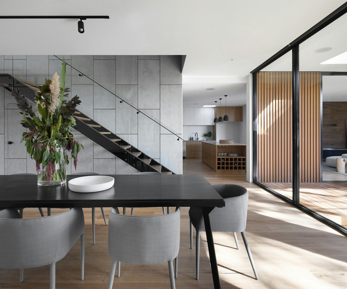 A dining interior that brings together warm wood, soft light and earthy tones